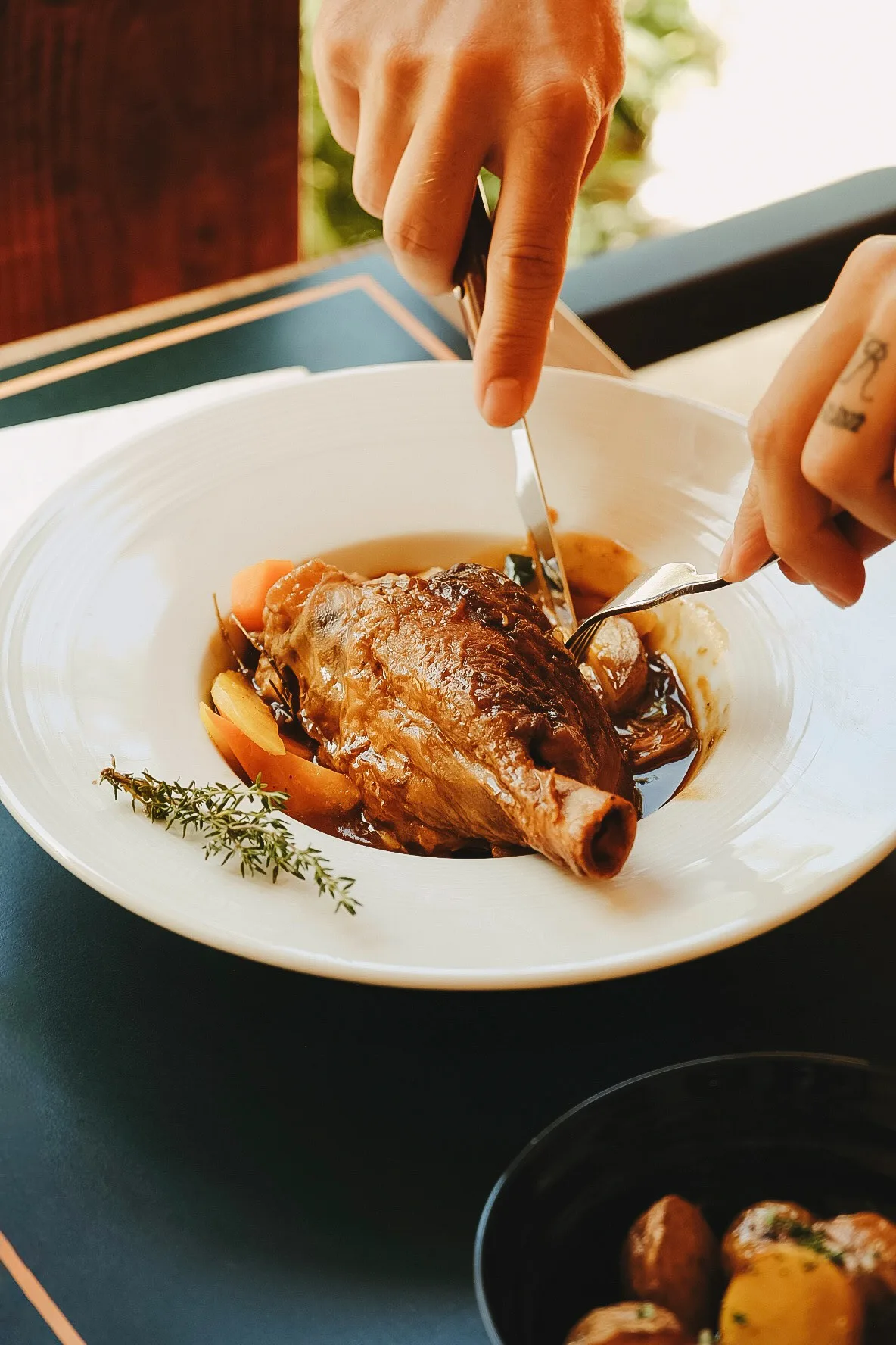 A slow-cooked meat dish served at the table